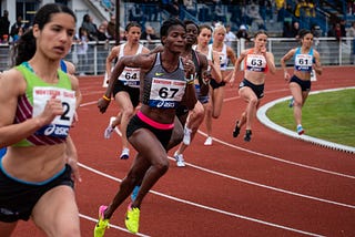 Side view of athletes running on the track