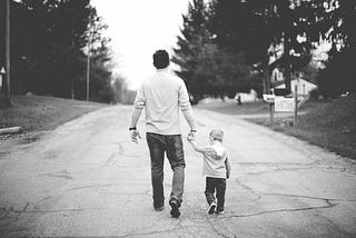 Being a dad at 46 — Dad and son walking on the street