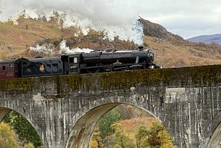 steam train going over a viaduct