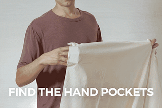 A GIF of a man fitting a duvet cover over a duvet