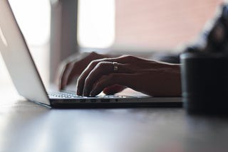 A man writing on his laptopt