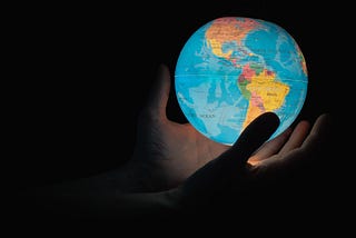 hands holding a globe