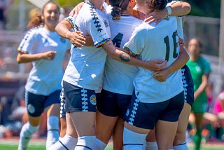 Oakland Soul players embrace after a goal scored.