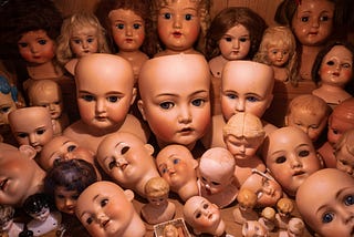 An abundance of white doll babies gathered together.