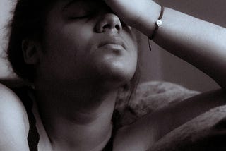 a woman with her hand on her forehead