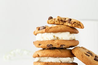 Two cookie and ice cream sandwiches stacked on top of each other.