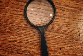 A magnifying glass on a wooden table