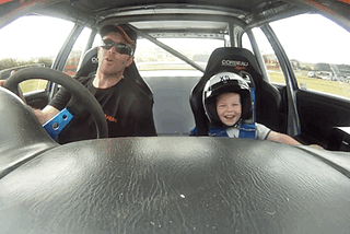 Happy child in the race car