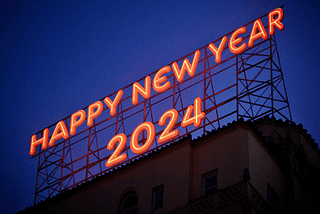 Happy New Year 2024 in a big bight red neon sign atop a building