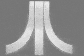 A grayscale, stylized Atari logo.