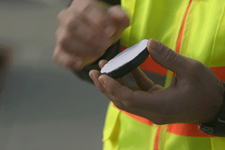 Animated GIF of person placing Pebble parking sensor onto pavement