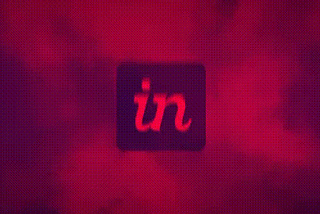 Dark, slightly pulsating image of the invision logo backed by reddish-purple clouds.