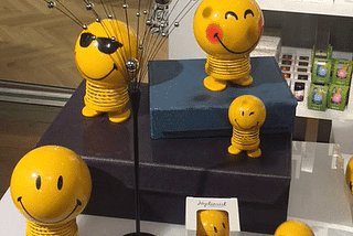 gif of Bouncy smiling faces on a display case (product is called Hoptimists)