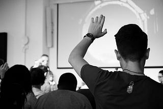 Classroom with a student raising his hand