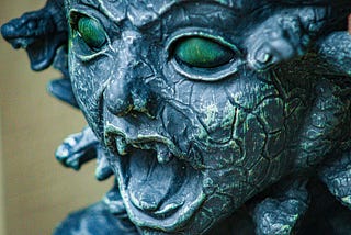 An extreme close-up of a stone stature of Medusa.