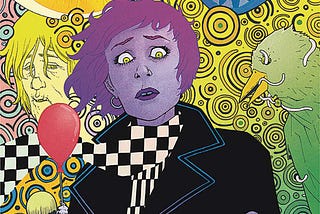 The cover of Ice Cream Man #15 features a light-purple-skinned woman with shortish dark-purple hair and lipstick, wearing a black jacket and a white/black checkered scarf. She looks down worryingly at the severed human finger she holds in her hand. Behind her is a psychedelic background, featuring a sinister-looking boys holding a balloon, a dead bird with worms crawling in and out of it’s eye sockets and mouth, and a vaguely tribal mask with a human eye seen though one of the eye holes.