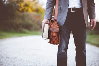 Career-changer carrying a notebook and bag