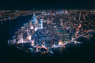 An aerial shot of downtown Manhattan at night.
