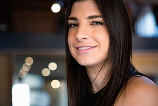 A woman smiles into the camera.