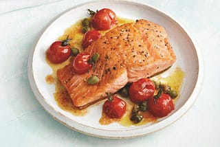 Salmon in a pan and on a plate.