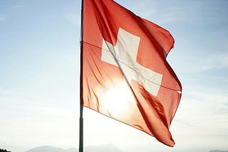 Switzerland flag at the top of a mountain