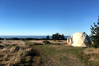 A white geodesic dome near the ocean.