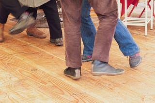 Picture of people’s legs dancing.