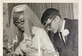 Young bride and groom cutting their wedding cake