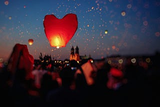 A heart-shaped candle lantern is released into the sky. Don’t do this at home — they are a wildfire hazard.