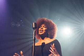 Woman singing on stage.