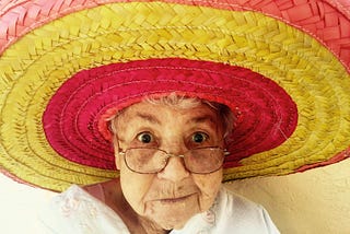 An elderly diva in a colourful sombrero.