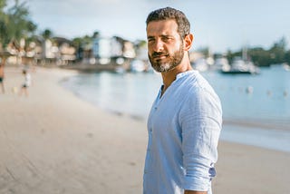 man on beach, looking satisfied with himself but that’s just my impression, I don’t know him personally