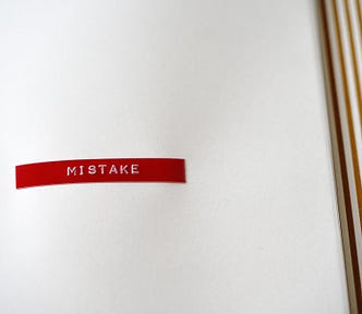 A white notebook page with a red “mistake” on it.