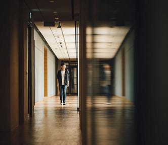 A child walking down a dark hallway.
