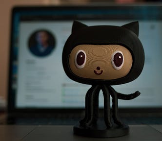 Octocat toy in front of a computer screen