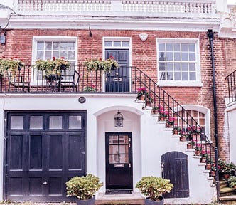 A brick house with a black garage and front door.