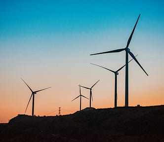 Wind turbines against a beautiful sunset.