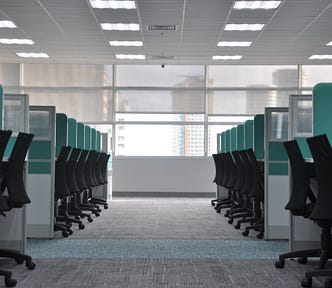 a an aisle of empty cubicles like those found in a call center