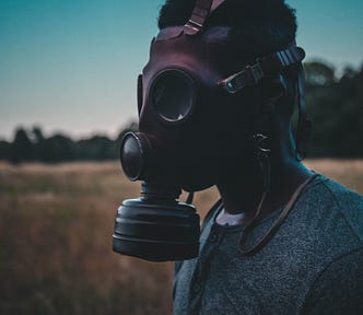 Man wearing gas mask.