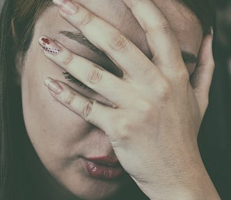 Woman with head in hand