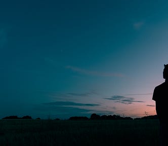 Image of a guy staring at the sky in the evening “I’m An Introvert: Here’s What That Means” on The Reflectionist