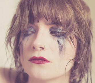 Woman with smudged make-up, implying she’s been crying