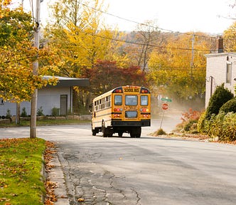 A school bus drives down a street.