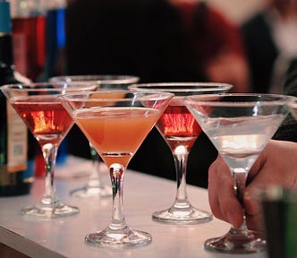 Colourful drinks in martini glasses