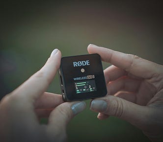 Hands holding a Rode Wireless Go
