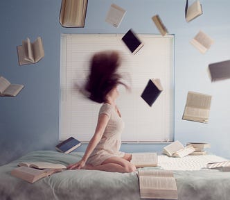 Girl with books around her