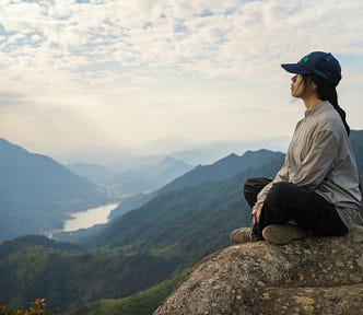 A woman on top of a mountain