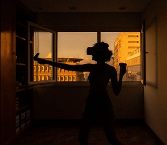 A person uses headset and controllers in a dark room.