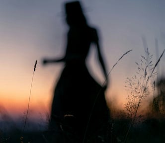 Silhouette of a woman in a meadow