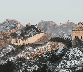 great wall of china with snow on the hills